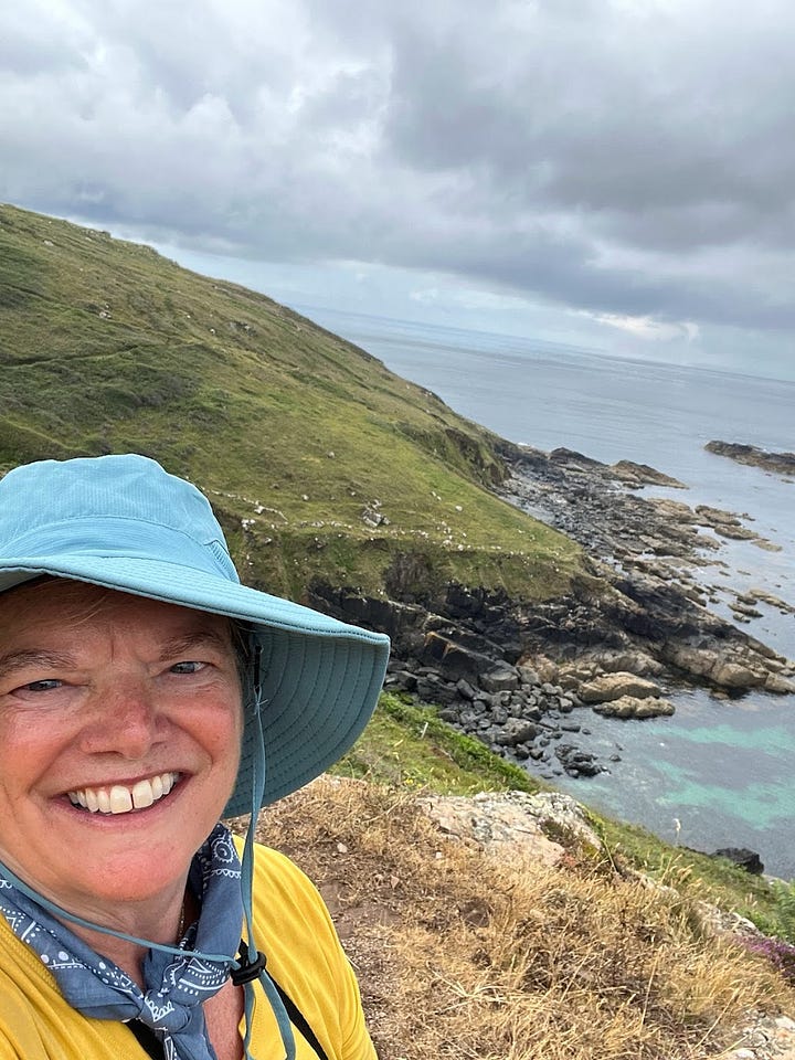 Top left: Melora Fern holding a trout smiling wearing a blue cap, Top right: Melora fern wearing a hiking hat smiling in front of a green coastline, Bottom left: Melora Fern smiling wearing a straw hat in front of a beach. Bottom right: Melora Fern smiling with her eyes closed wearing a blue beanie