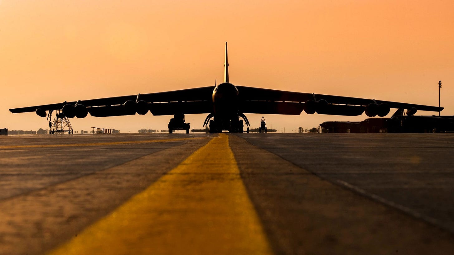 A U.S. Air Force B-52H Stratofortress silhouetted at dusk on the flightline at Minot Air Force Base, North Dakota