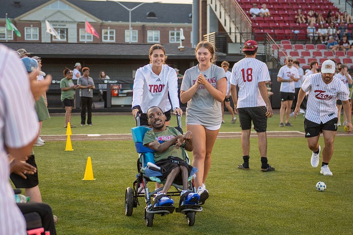 TROY student-athletes help celebrate opening night of the Miracle League with Miracle League players on Monday night at Riddle-Pace field. The Troy Miracle League in Troy, Alabama, provides children and adults of all ages with disabilities the opportunity to play baseball, and have fun. (Photos/Joey Meredith)