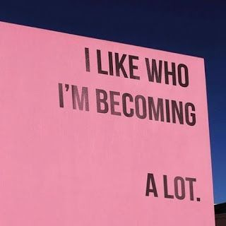 This may contain: a pink sign that says i like who i'm becoming alot