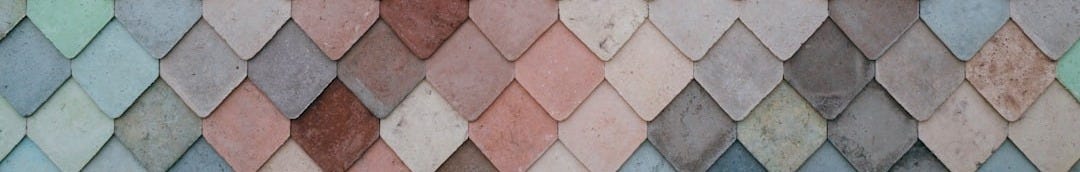 a multicolored tile wall with a pattern of small squares a multicolored tile wall with a pattern of small squares