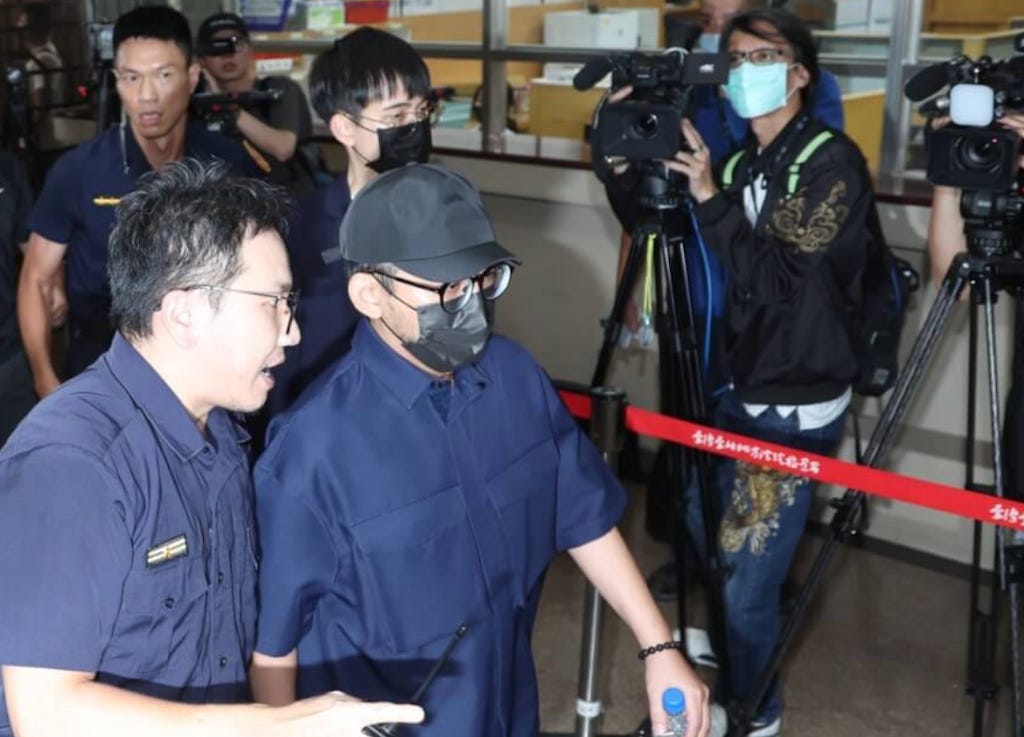 Mickey Huang is taken in for police questioning, 2023. (CNA photo)
