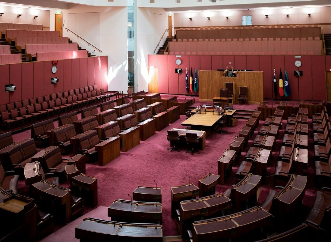 a large room filled with lots of wooden chairs