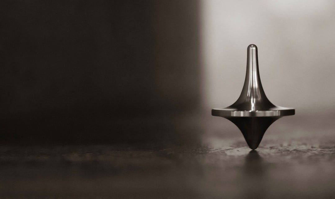 Spinning top on brown wooden table