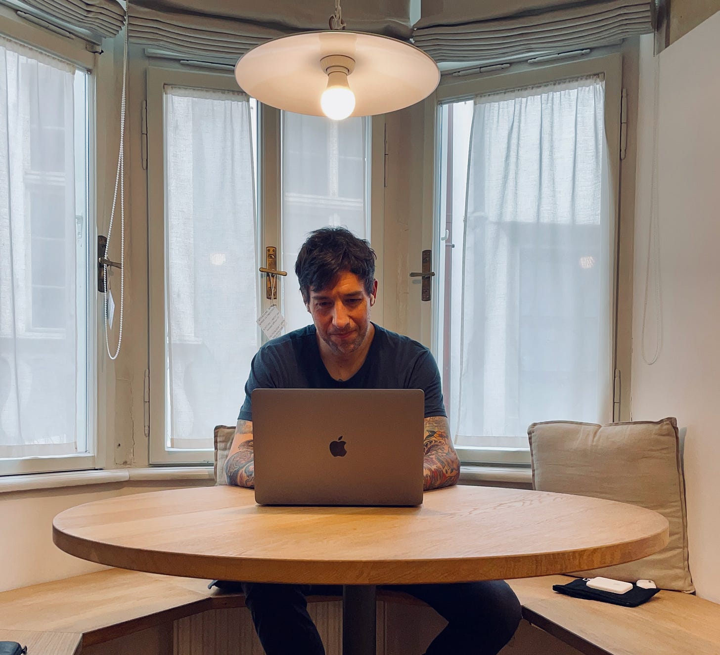 Chris sitting in front of his macbook editing his book