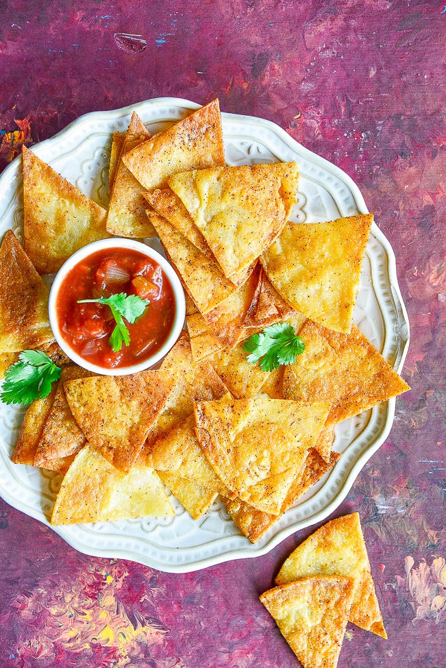 Overhead view of a plate of baked corn tortilla chips 