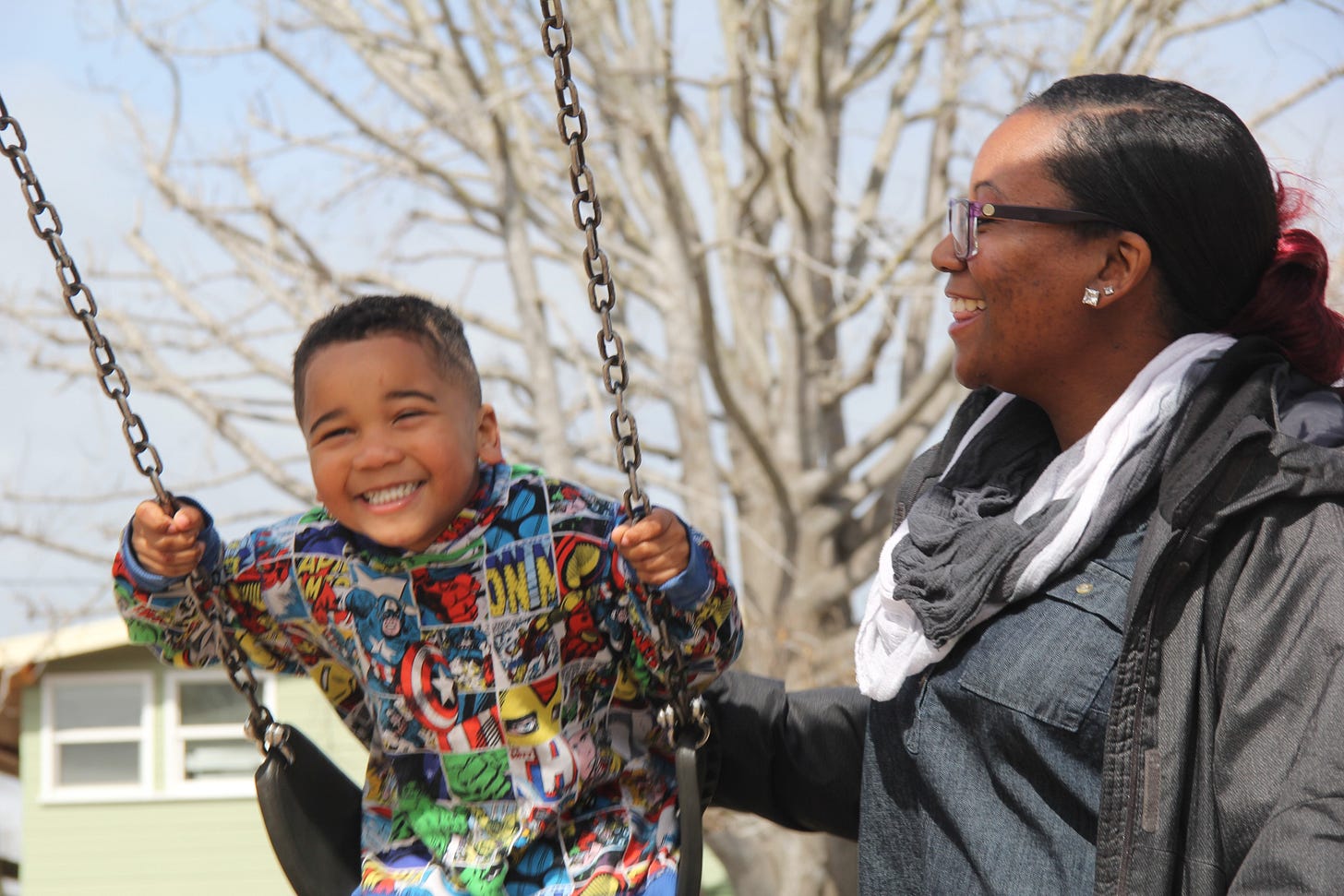 mom pushing little boy on a swing. mom pushing little boy on a swing.