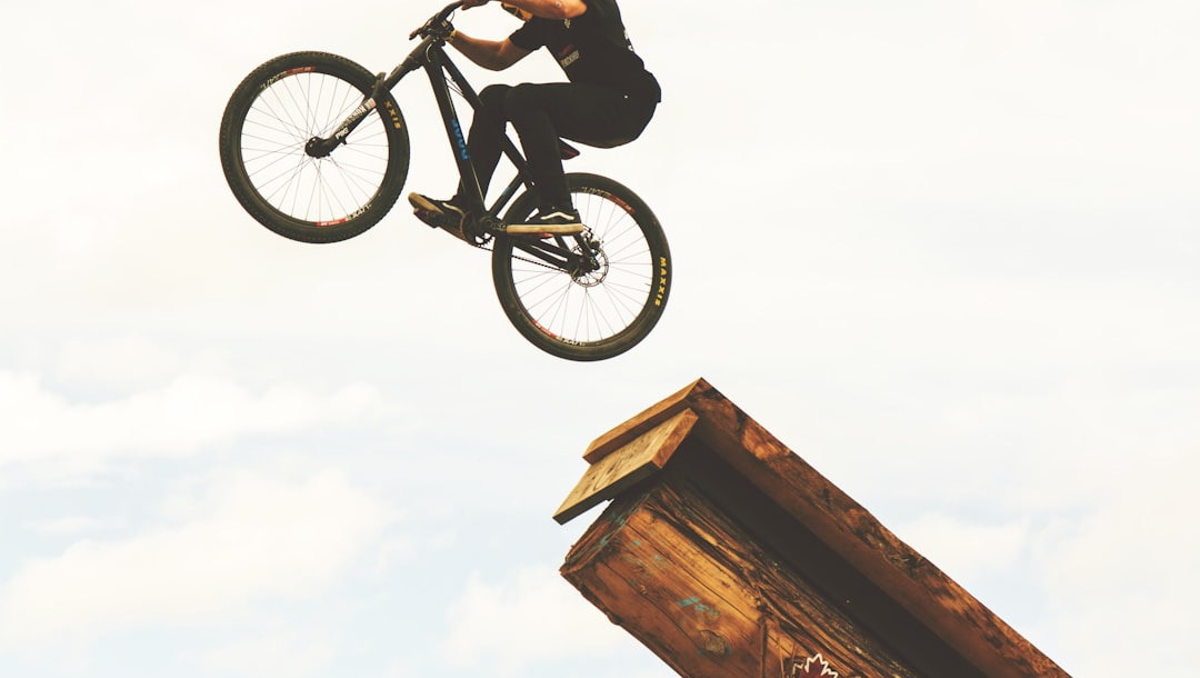man riding on BMX bike on mid air during daytime man riding on BMX bike on mid air during daytime