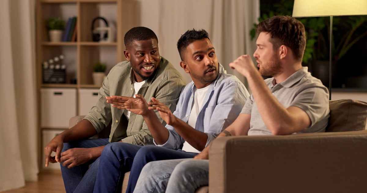 Male friends talking at home