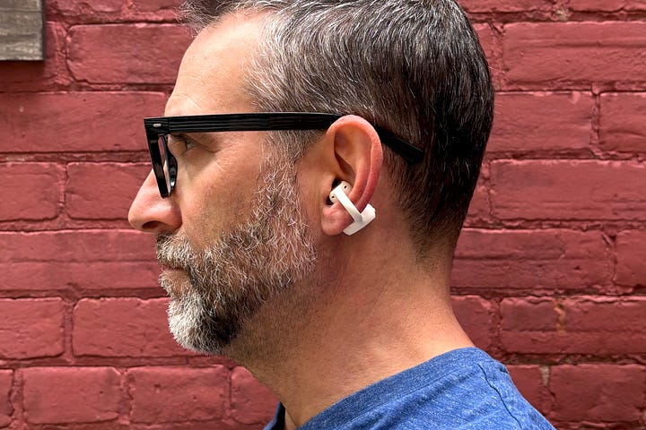 Two photos of the author seen from the side wearing Apple AirPods Pro 3 and Baseus Inspire XC1.