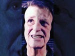 Johnny Profane Âû, original digital icon. Face of Johnny Profane Âû, wearing headphones as a selfie. In the dark background his eyes peer at the viewer.