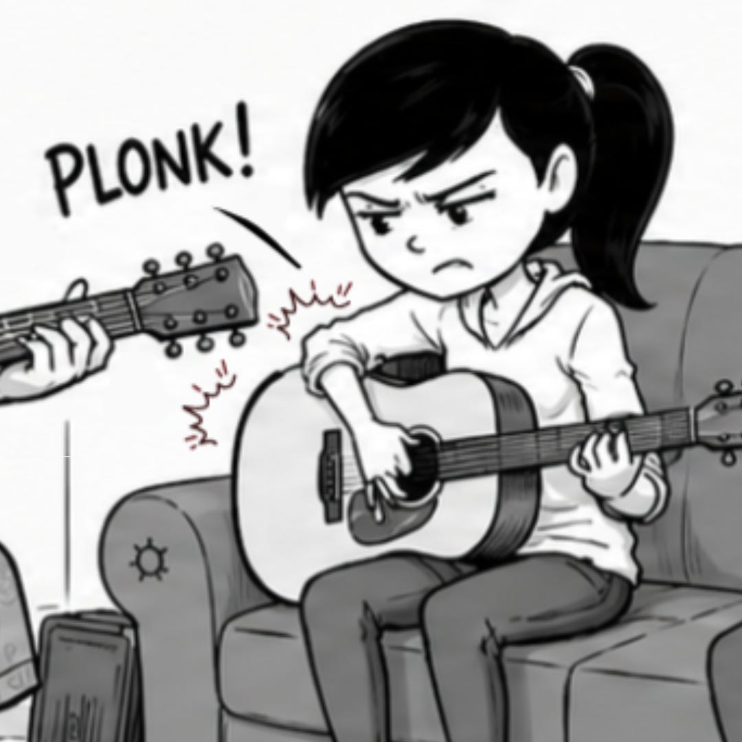A guitar teacher demonstrates a chord while Zara and Misha practice.