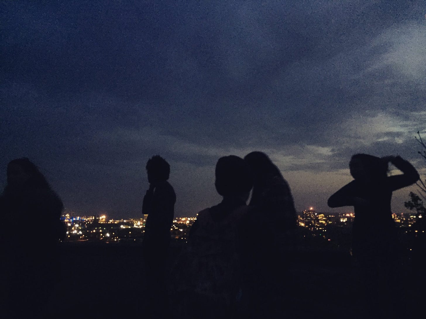 A behind-the-scenes moment from the web series, in which five of the actors are silhouetted against the night sky.
