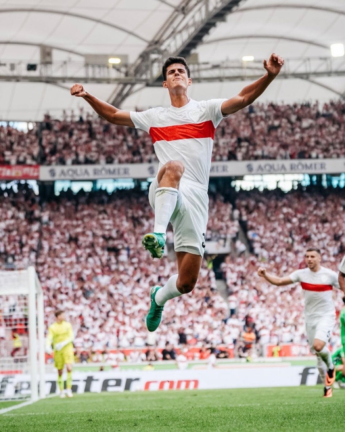 May be an image of 3 people, people playing football, people playing soccer, stadium and text