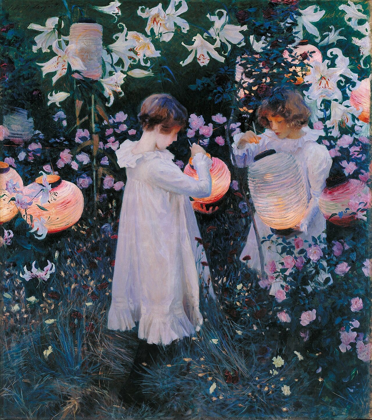 Two young girls in white dresses lighting Chinese lanterns among pink roses and lilies at dusk Two young girls in white dresses lighting Chinese lanterns among pink roses and lilies at dusk