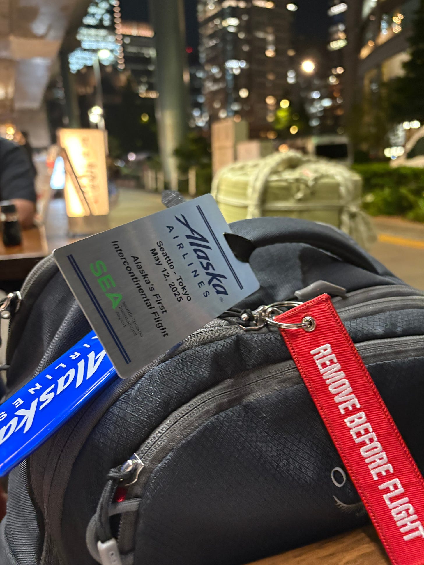 Flaunting my inaugural flight luggage tag on the streets of Tokyo