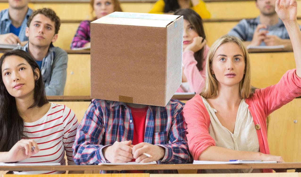 student wirh cardboard box on head
