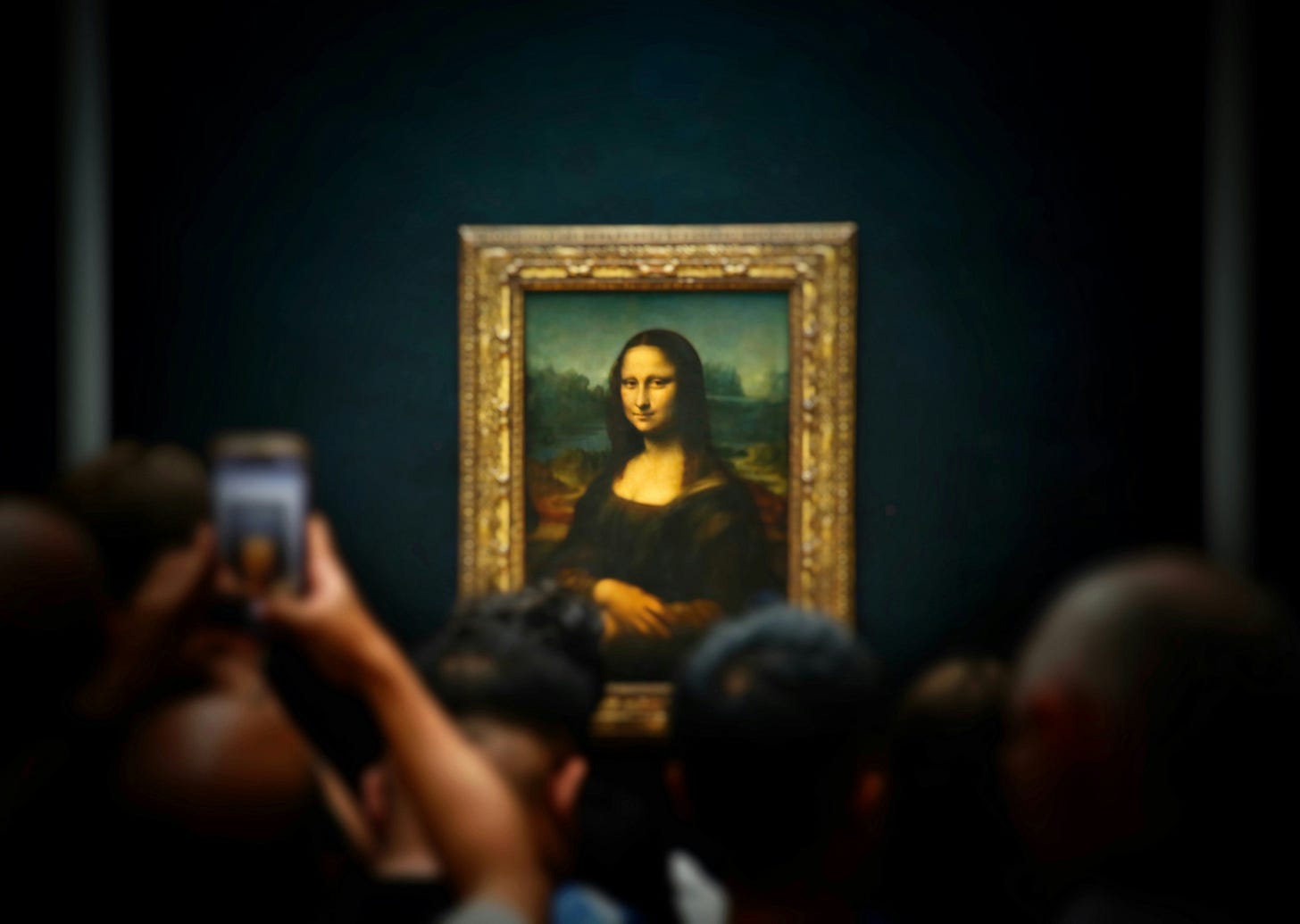 Tourists photographing the famous Mona Lisa painting by Leonardo da Vinci in its ornate golden frame at the Louvre Museum in Paris, with visitors holding up phones to capture the masterpiece Tourists photographing the famous Mona Lisa painting by Leonardo da Vinci in its ornate golden frame at the Louvre Museum in Paris, with visitors holding up phones to capture the masterpiece