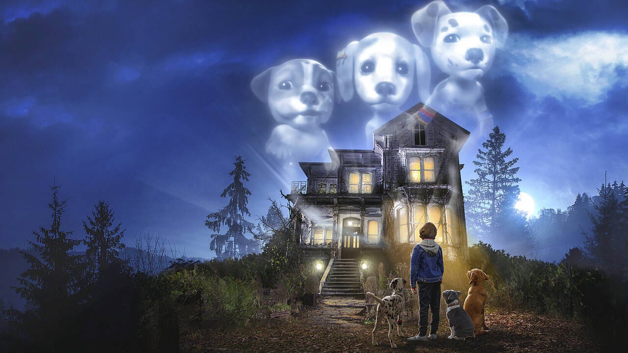 A little boy and three dogs stand in front of a standard-issue haunted house, over which looms the gigantic ghost images of the same three dogs.