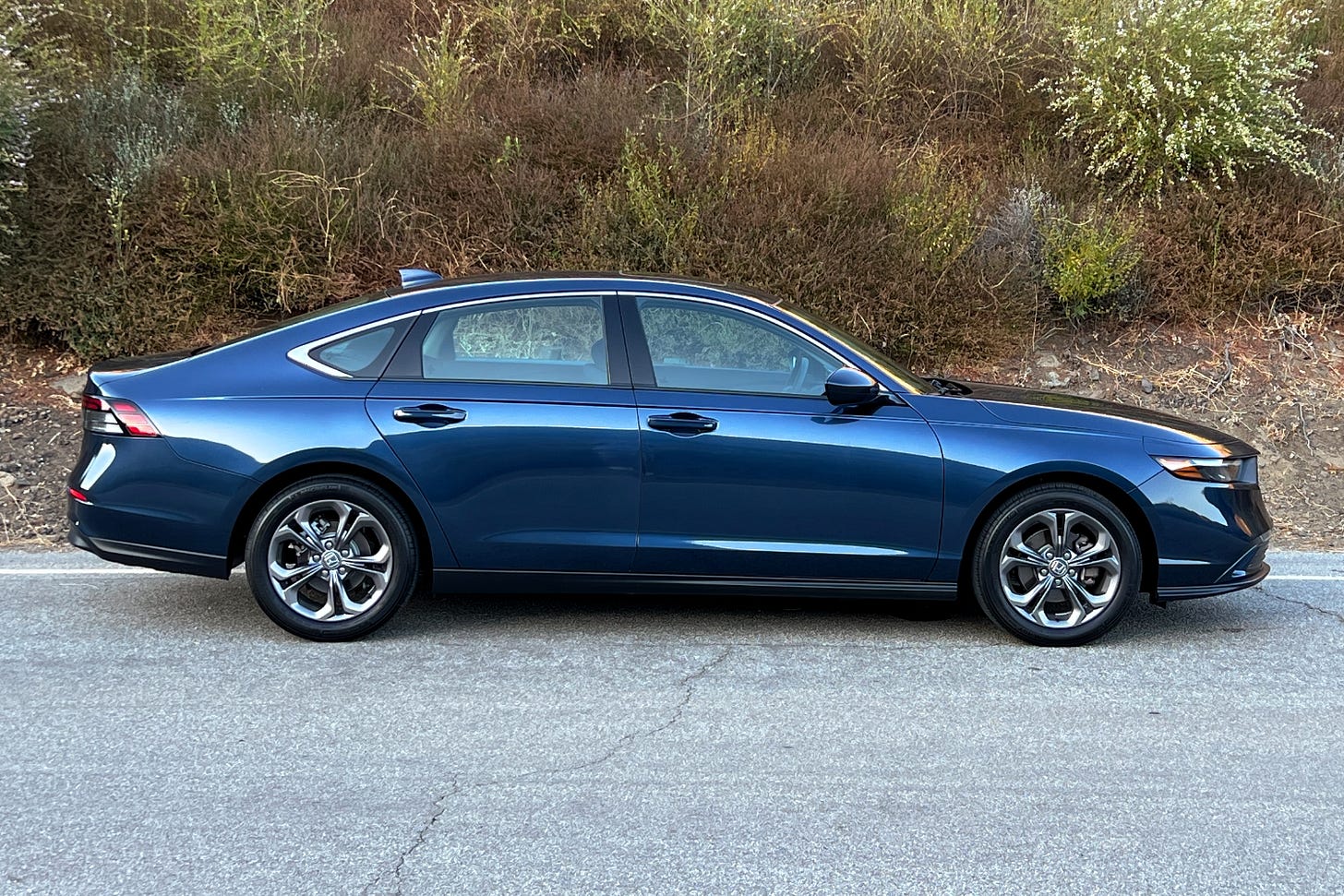 A side view of a blue 2023 Honda Accord EX parked on the side of a road.