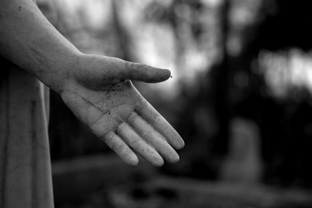 a statue of a person's hand holding something a statue of a person's hand holding something