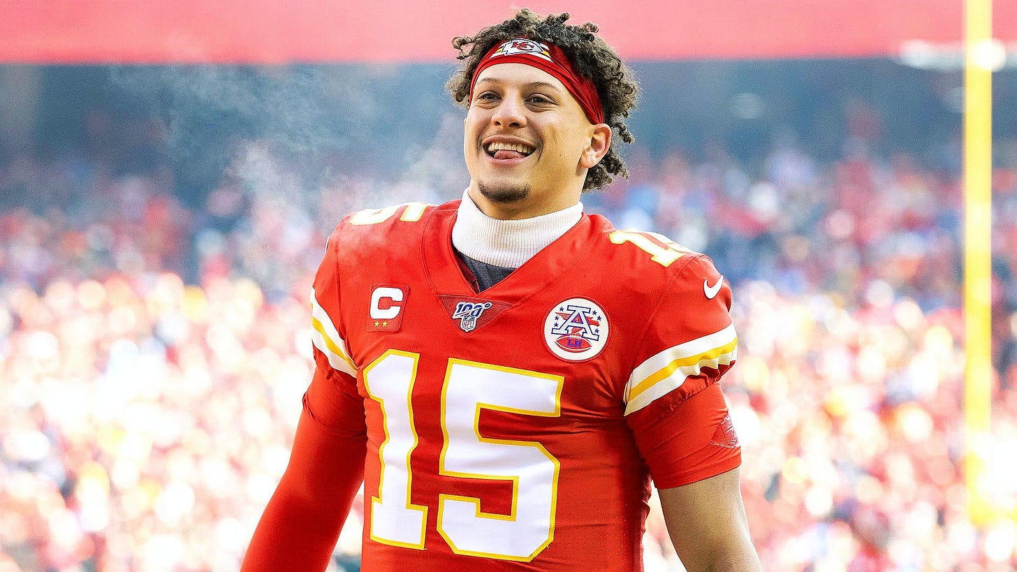 Patrick Mahomes on football wearing the red #15 jersey smiling