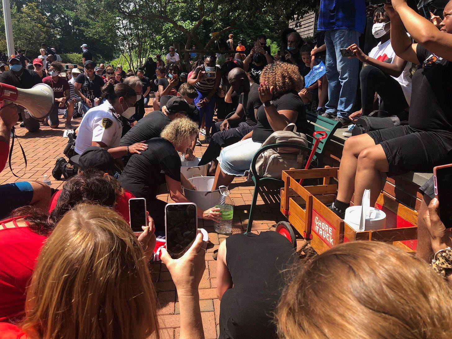 Protestors washing the feet of BLM movement leaders. : r/pics