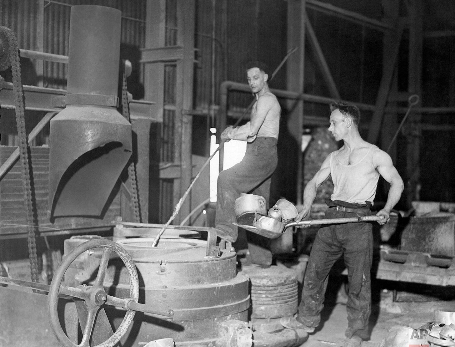 From kitchen to cockpit: Old aluminum saucepans from across Great Britain are ladled into a smelting pot on Sept. 17, 1940. These civilian contributions were vital in transforming household items into new aircraft parts, supporting the Royal Air Force during the Battle of Britain.