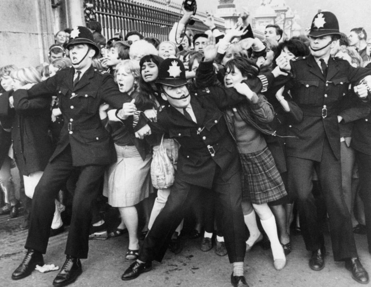 Police hold back Beatles fans in London on Oct. 26, 1965.