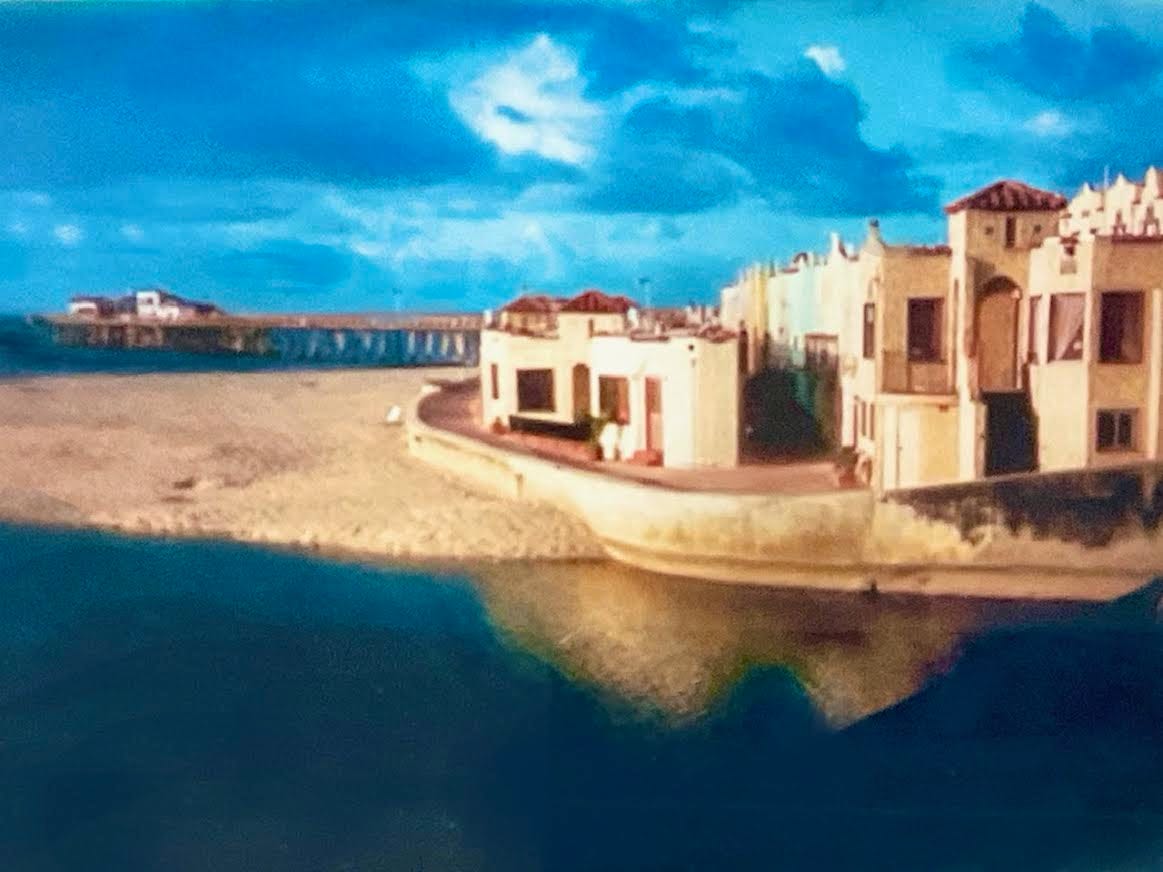 Embellished photo by Sherry Killam Arts of the Wharf and beach apartments in Capitola, California.