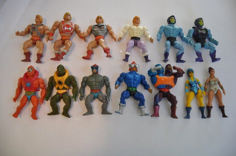 May include: A collection of vintage action figures, including He-Man, Skeletor, Beast Man, and Teela. The figures are made of plastic and have a variety of colors, including red, blue, green, and yellow. The figures are posed in a variety of action poses.