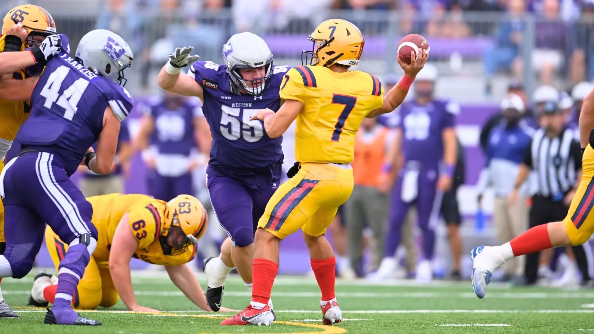 Football player about to tackle a quarterback Football player about to tackle a quarterback