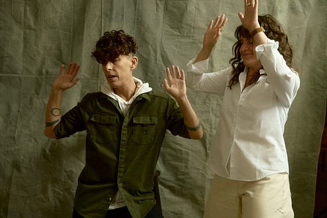 Three imagines of Meg and Andrea in dancing. In the final one, Andrea is moving toward the edge of the frame, and it appears Meg is trying to pull them back into it.