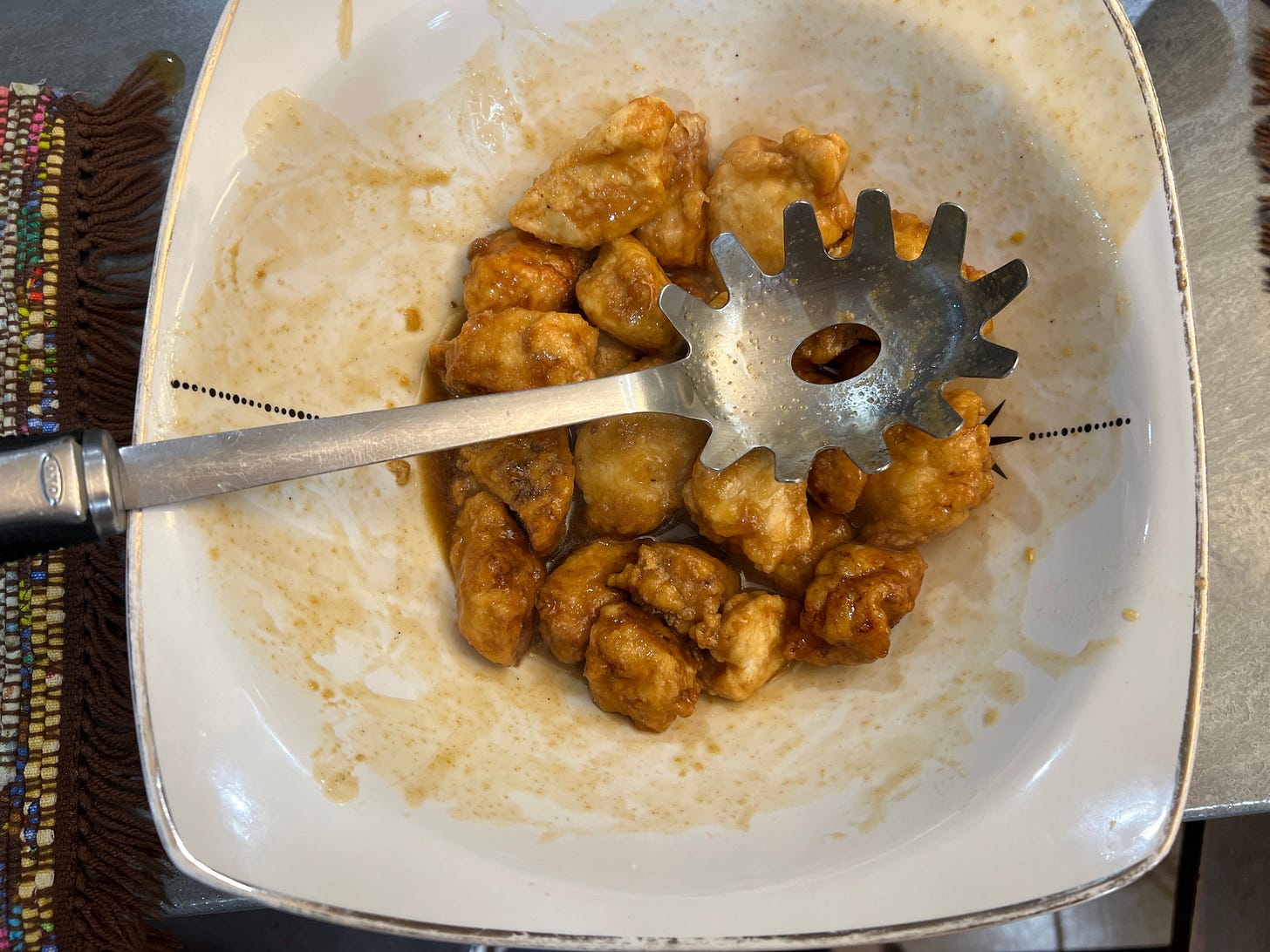 photograph of orange chicken in a white bowl