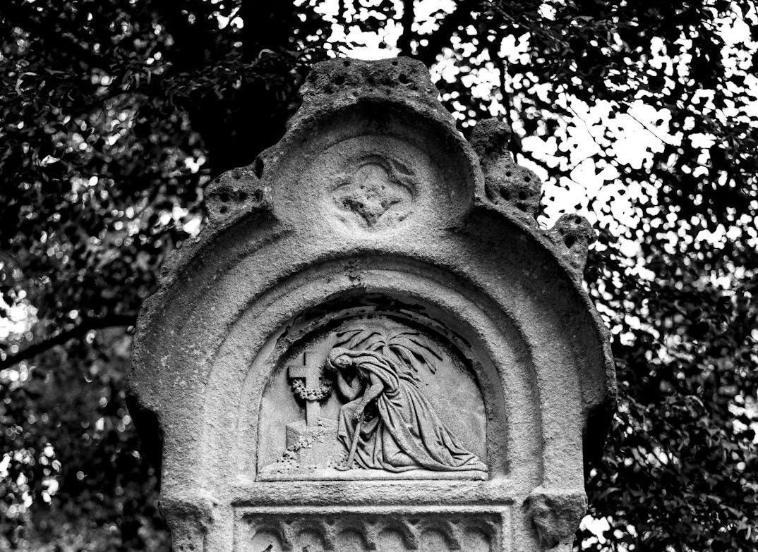 grayscale photo of concrete statue