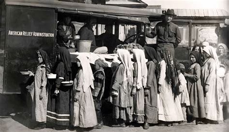American Relief Administration employees distribute food to Bashkir children suffering from ...