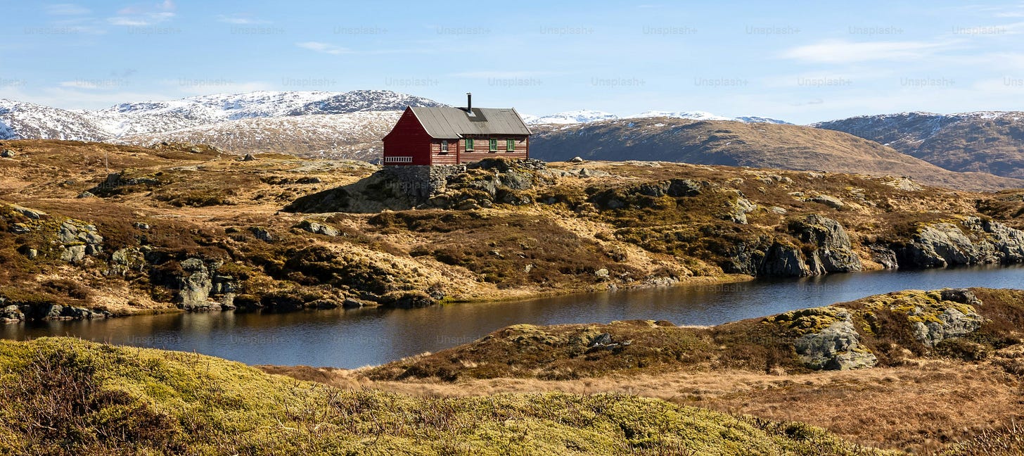 Mountain landscape with red cabin and lake near Bergen in spring Mountain landscape with red cabin and lake near Bergen in spring