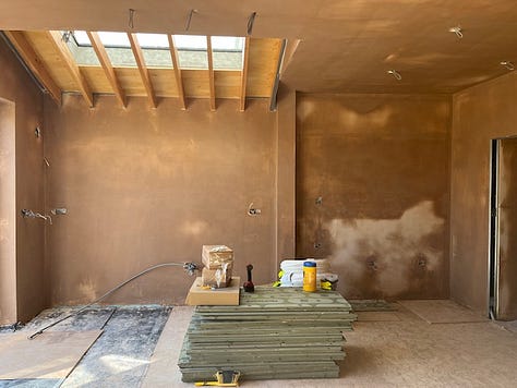 plastered walls; pitched roof; exposed roof beams; underfloor heating; cork flooring; pocket sliding doors