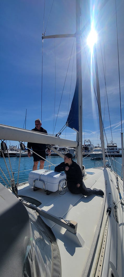 3 pictures of the interior and exterior of a monohull. There is visible water damage on the floor of the salon.