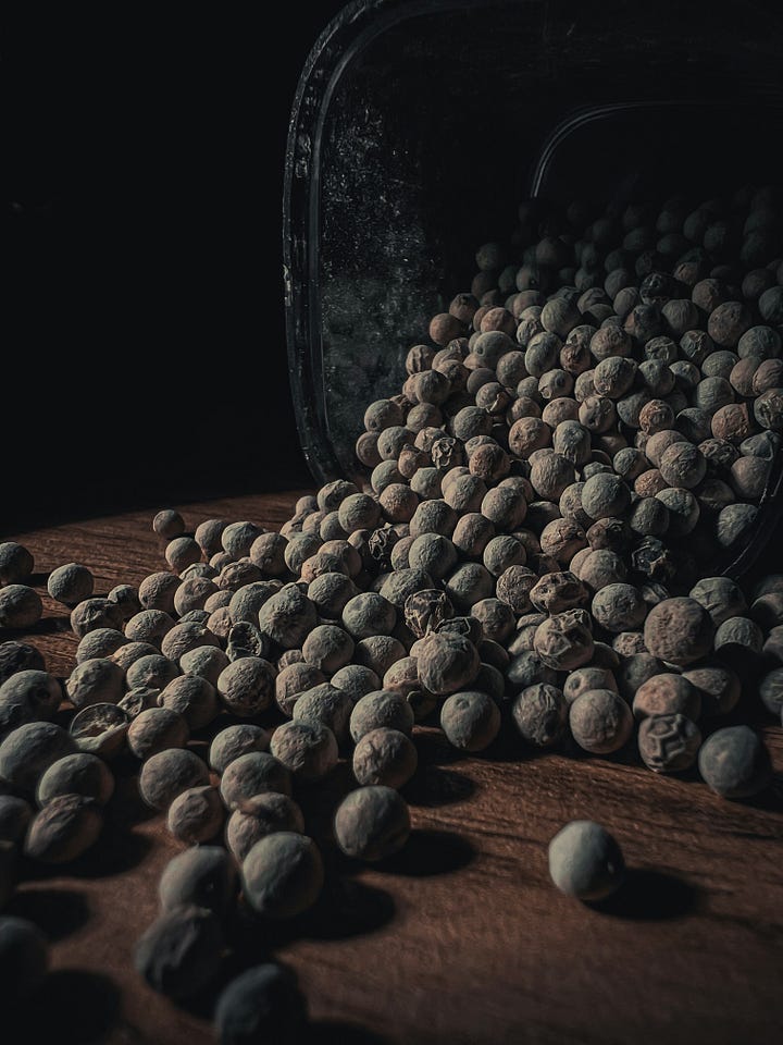 Cut Wheels of Cheese. Whole Peppercorns. Photos by Alexander Maasch and Sina Katrachi via Unsplash.
