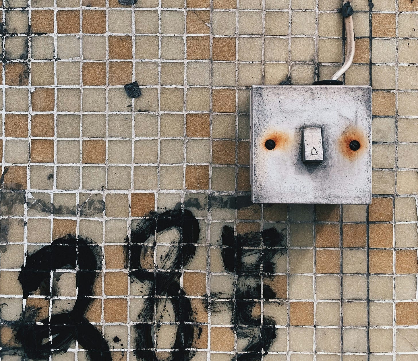 white wall mounted switch on brown brick wall