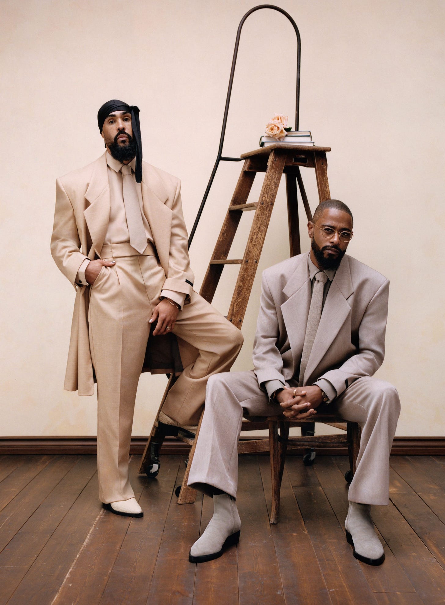 Image may contain Keith Stanfield Lamp Adult Person Accessories Formal Wear Tie Clothing Coat Sitting and Footwear