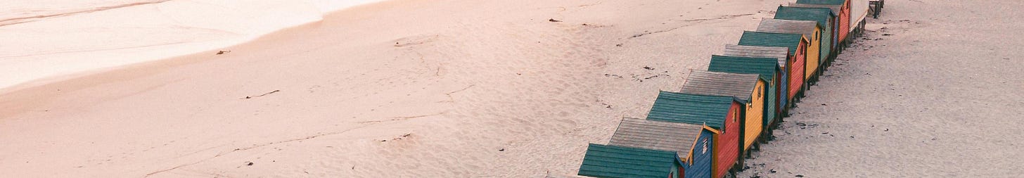 beach with row of colorful cabins beach with row of colorful cabins