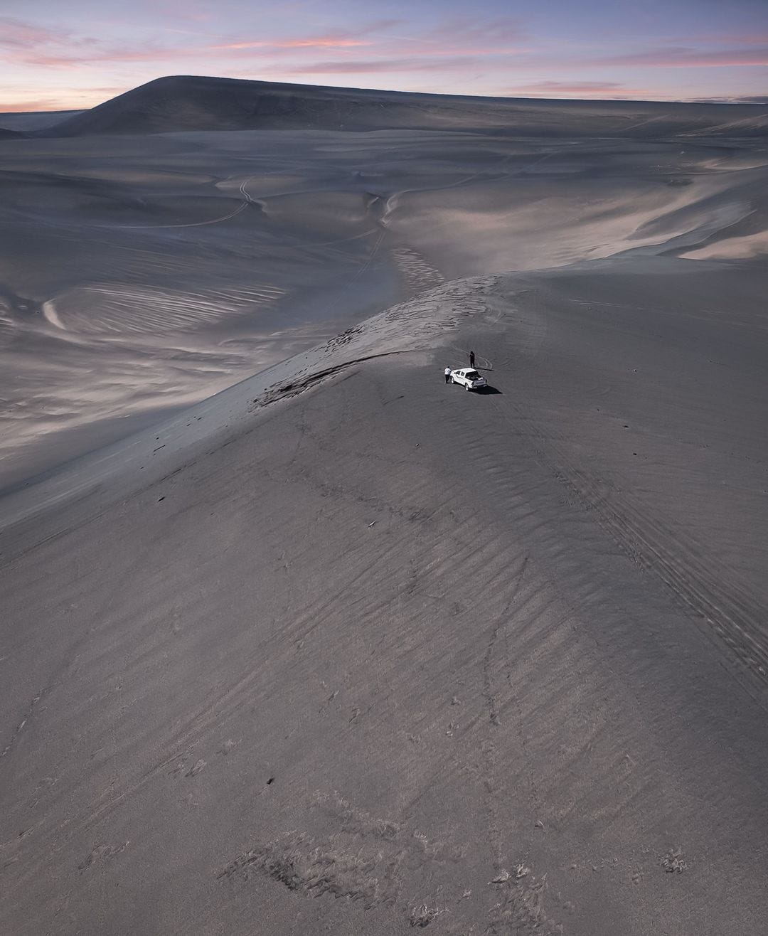 A car on a sandy hill

Description automatically generated