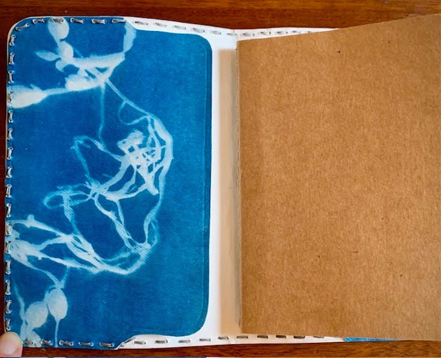 A gallery of four images includes: three small handbound notebooks and a vintage typewriter