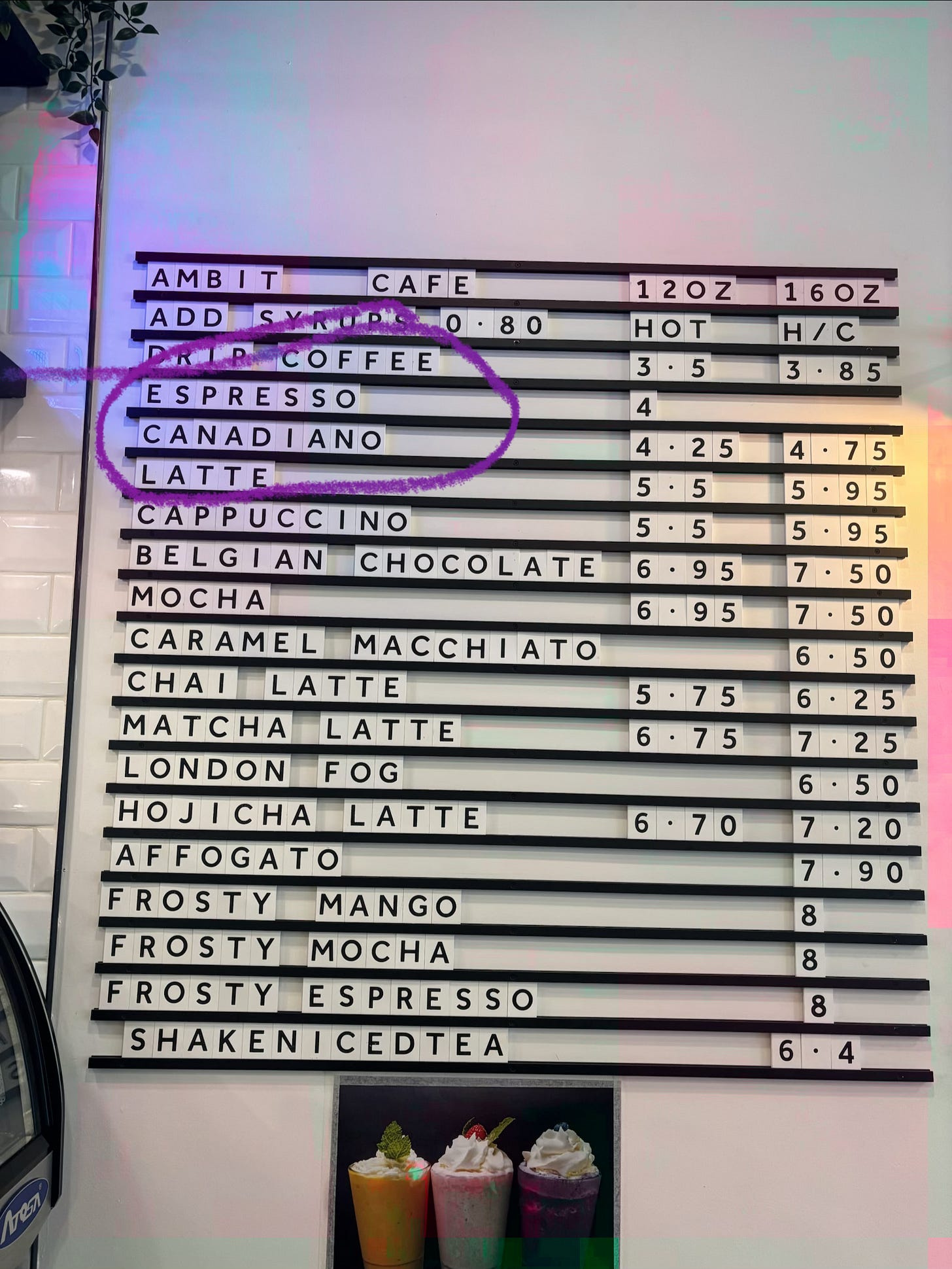 A sign advertising fancy coffee has replaced Americano with Canadiano.