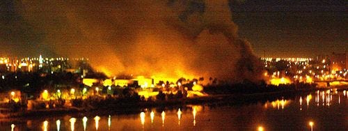 Massive bombardment: fires rage in Baghdad after the city was hit by a series of coalition airstrikes in March 2003 Massive bombardment: fires rage in Baghdad after the city was hit by a series of coalition airstrikes in March 2003