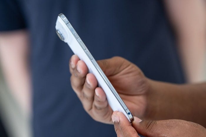 Person holding a white iPhone Air.