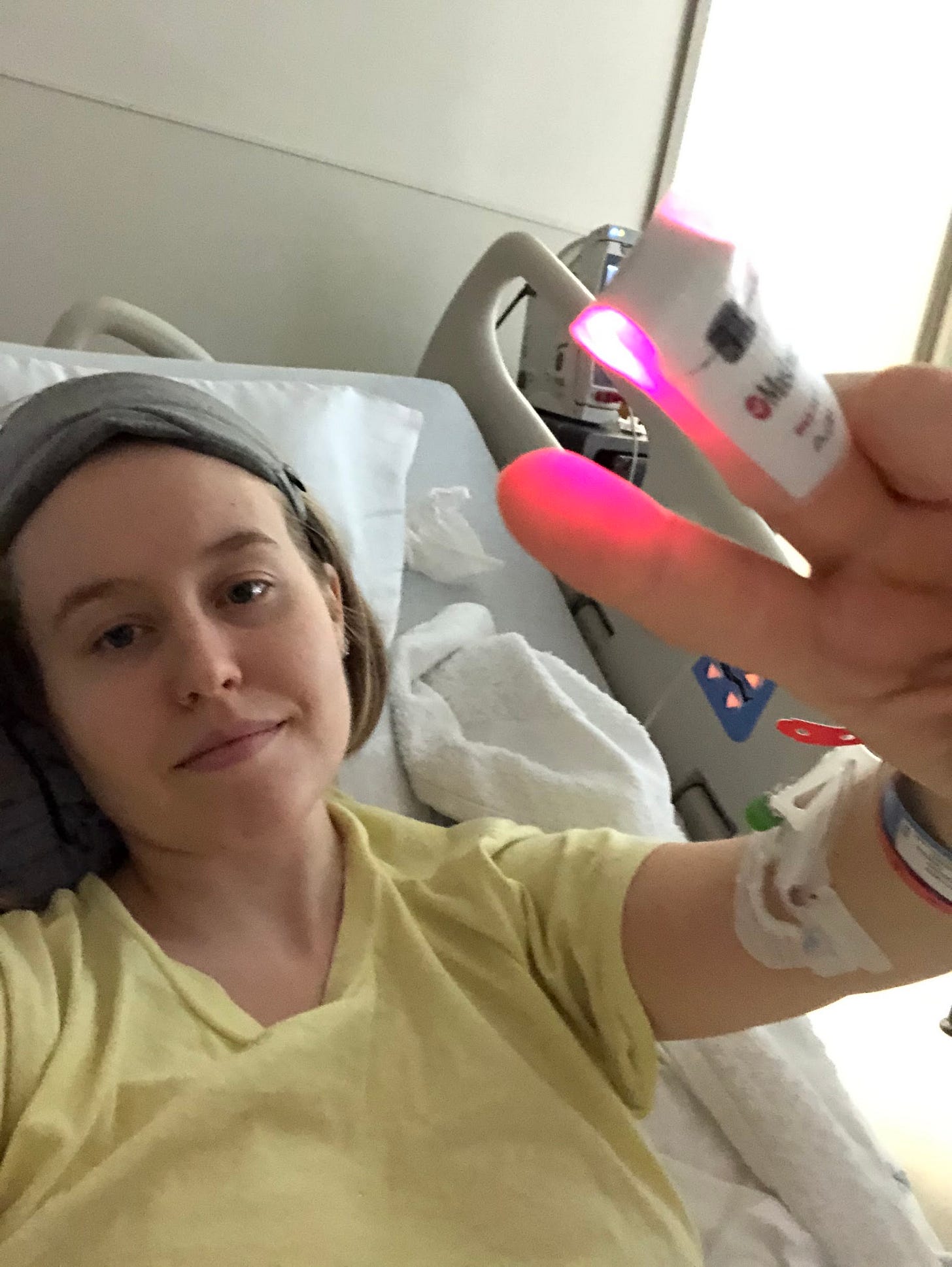 Fi in the hospital with Covid in 2020. They're holding up a peace sign