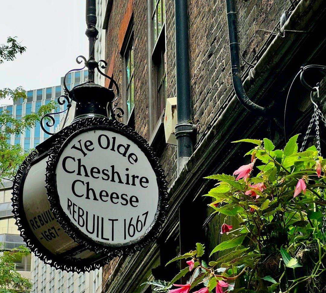 a black and white sign hanging from the side of a building